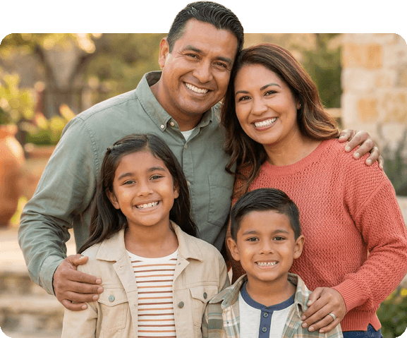 Happy hispanic family smiling - Smiles of Gonzales dental office in Gonzales TX